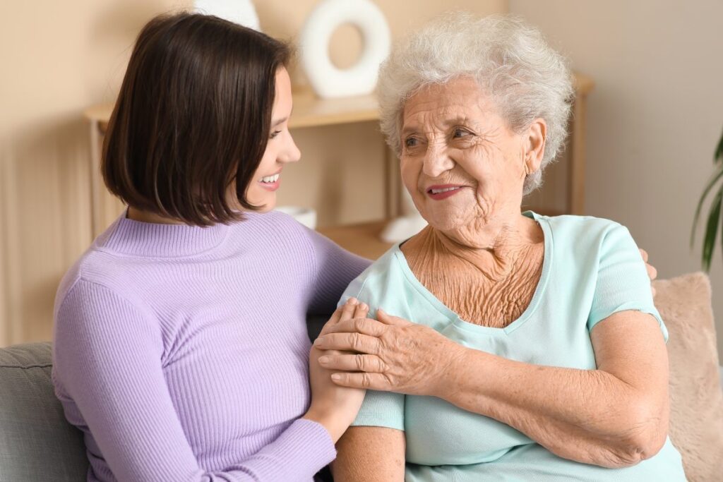 The Gardens of Amarillo | Senior woman comforted by caregiver